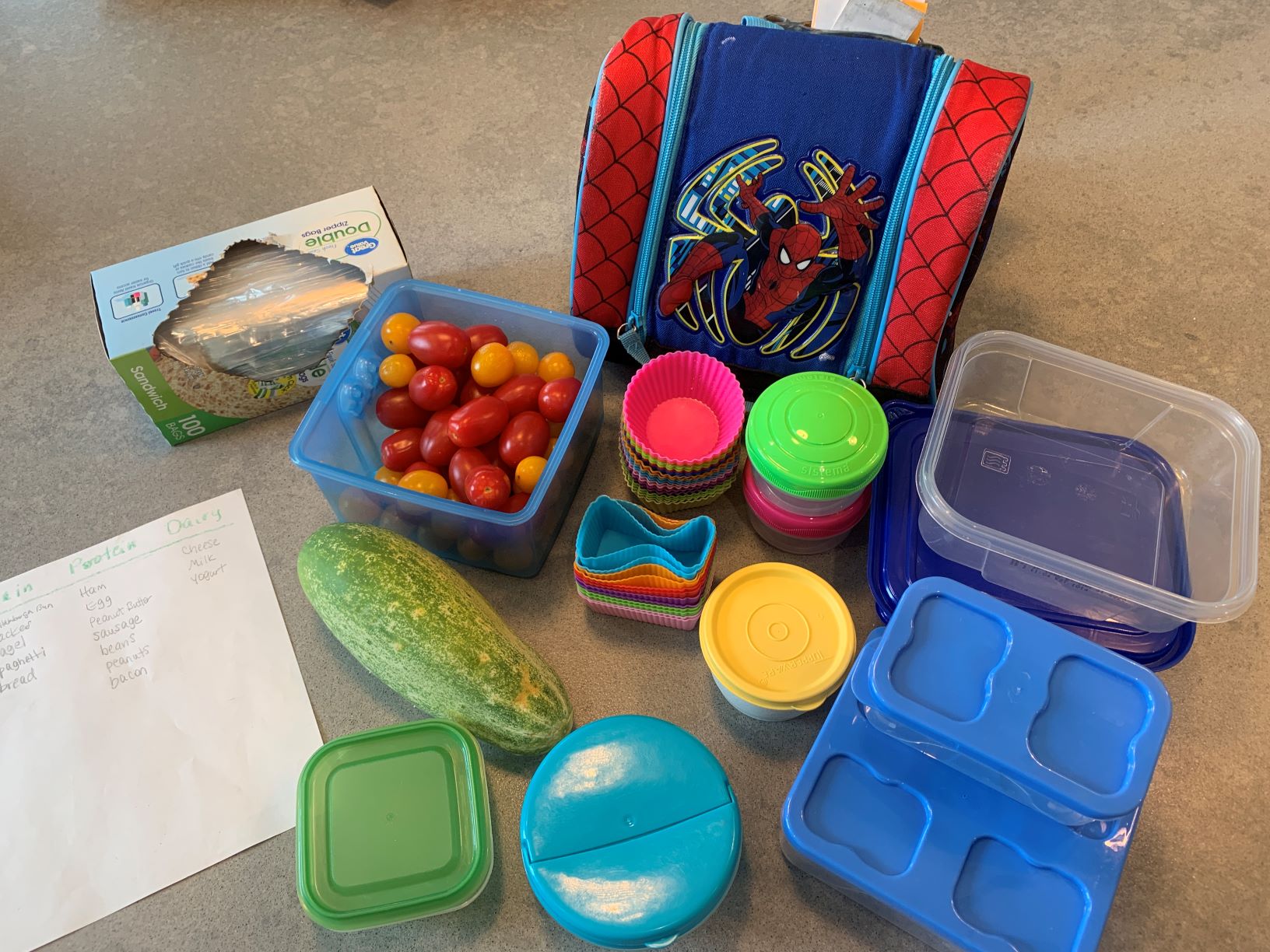 small containers, lunch bag, tomatoes, cucumber