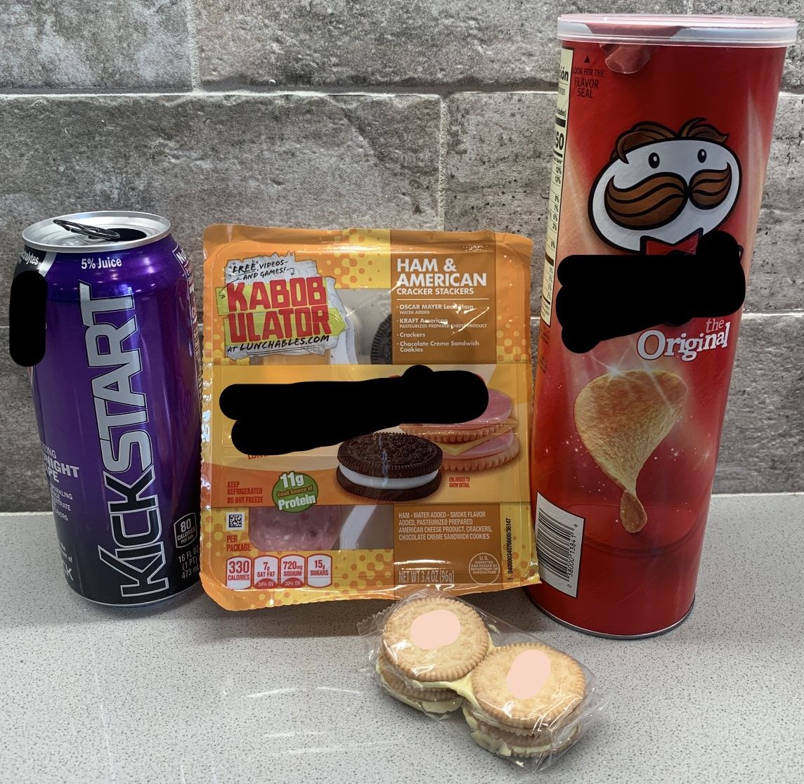photo of prepackaged lunch, cookies, chips, and caffeine drink