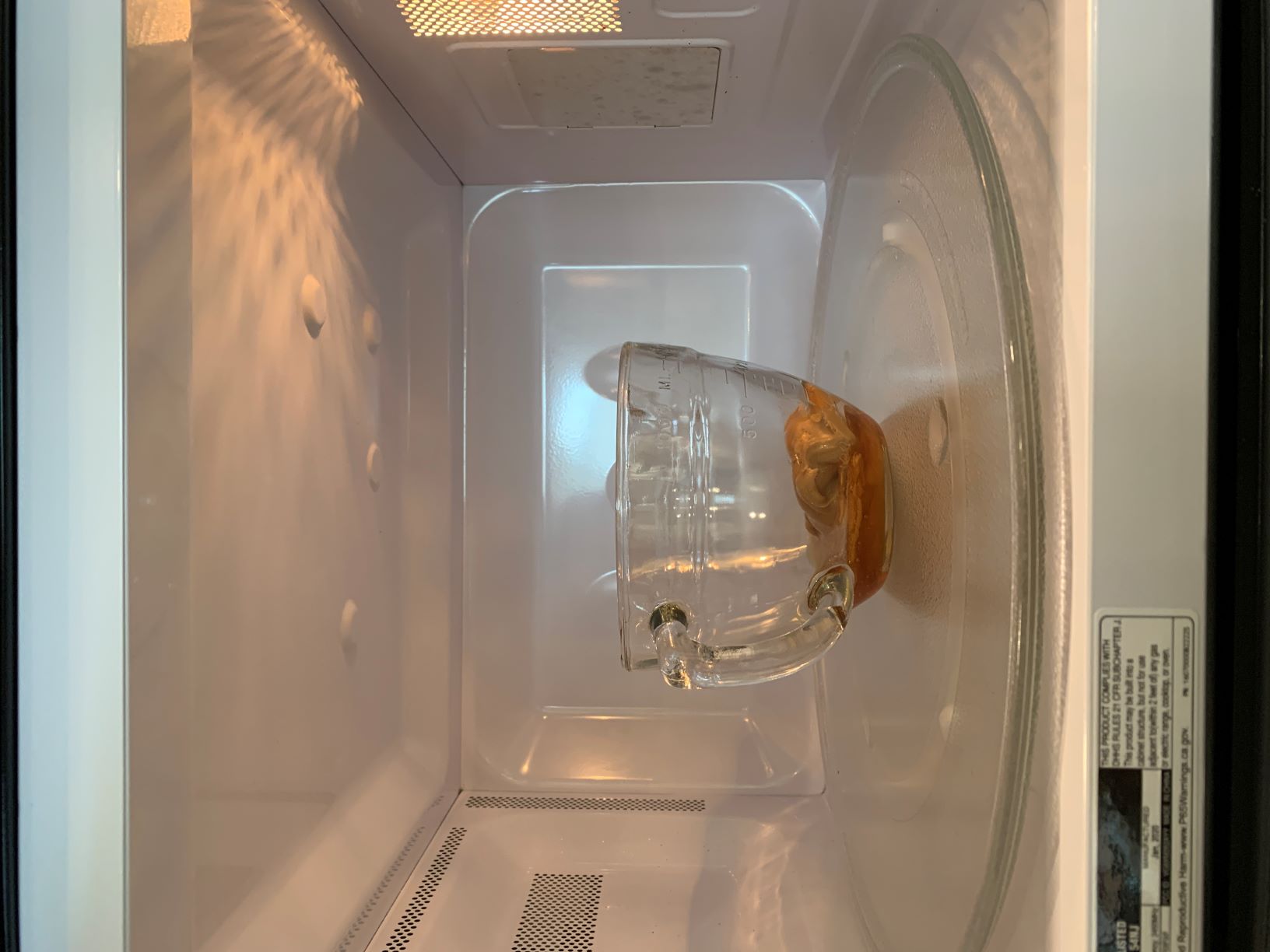 Heat honey in microwave.