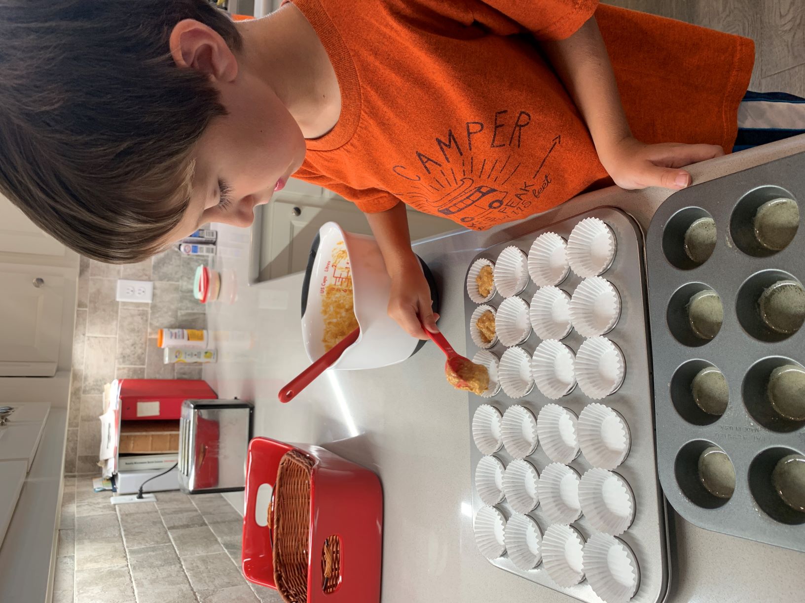 helper putting batter into pans