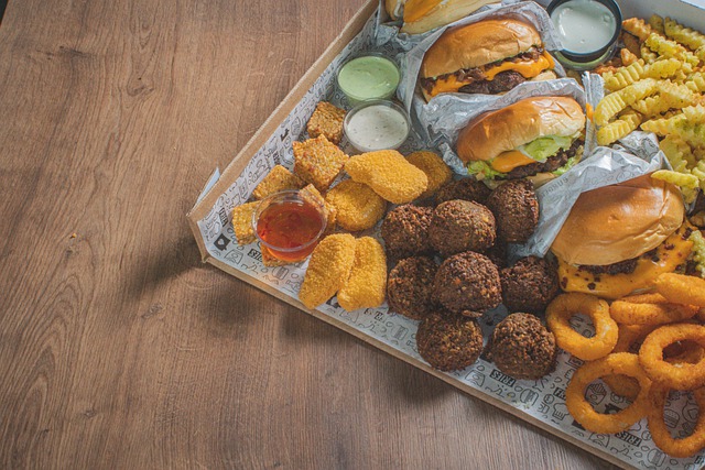 tray of hamburgers, chicken nuggets, fries, sauces