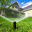 Landscape sprinkler watering home lawn