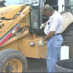 fleet maintenance worker filling up bulldozer with gas