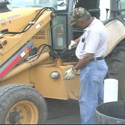 worker fueling up bulldozer