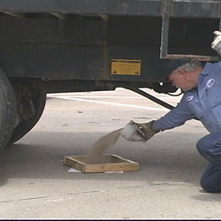 worker peoperly disposing of vehicle fluids