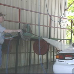 employee cleaning up leak from construction equipment