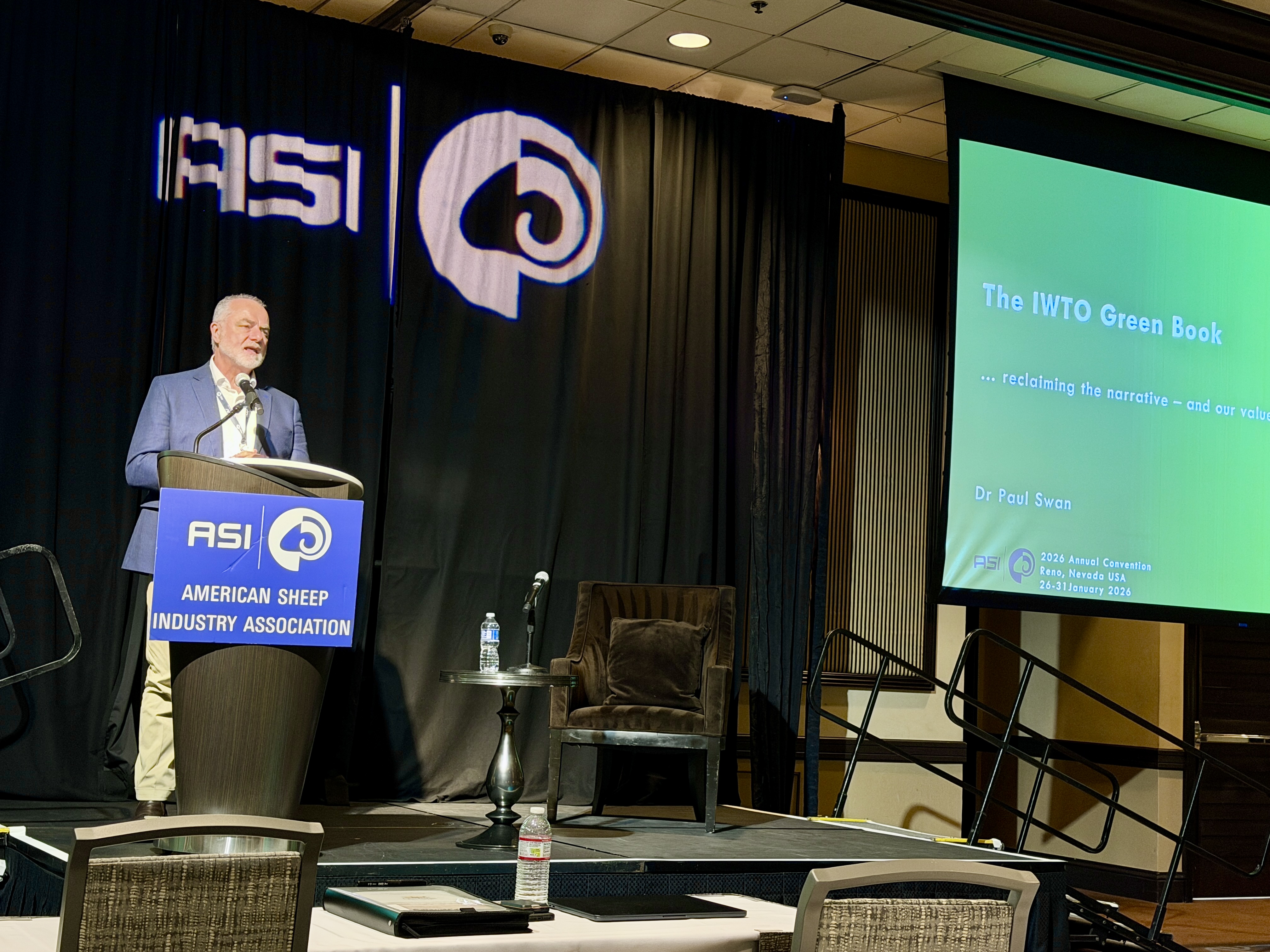 A speaker presents from behind a podium