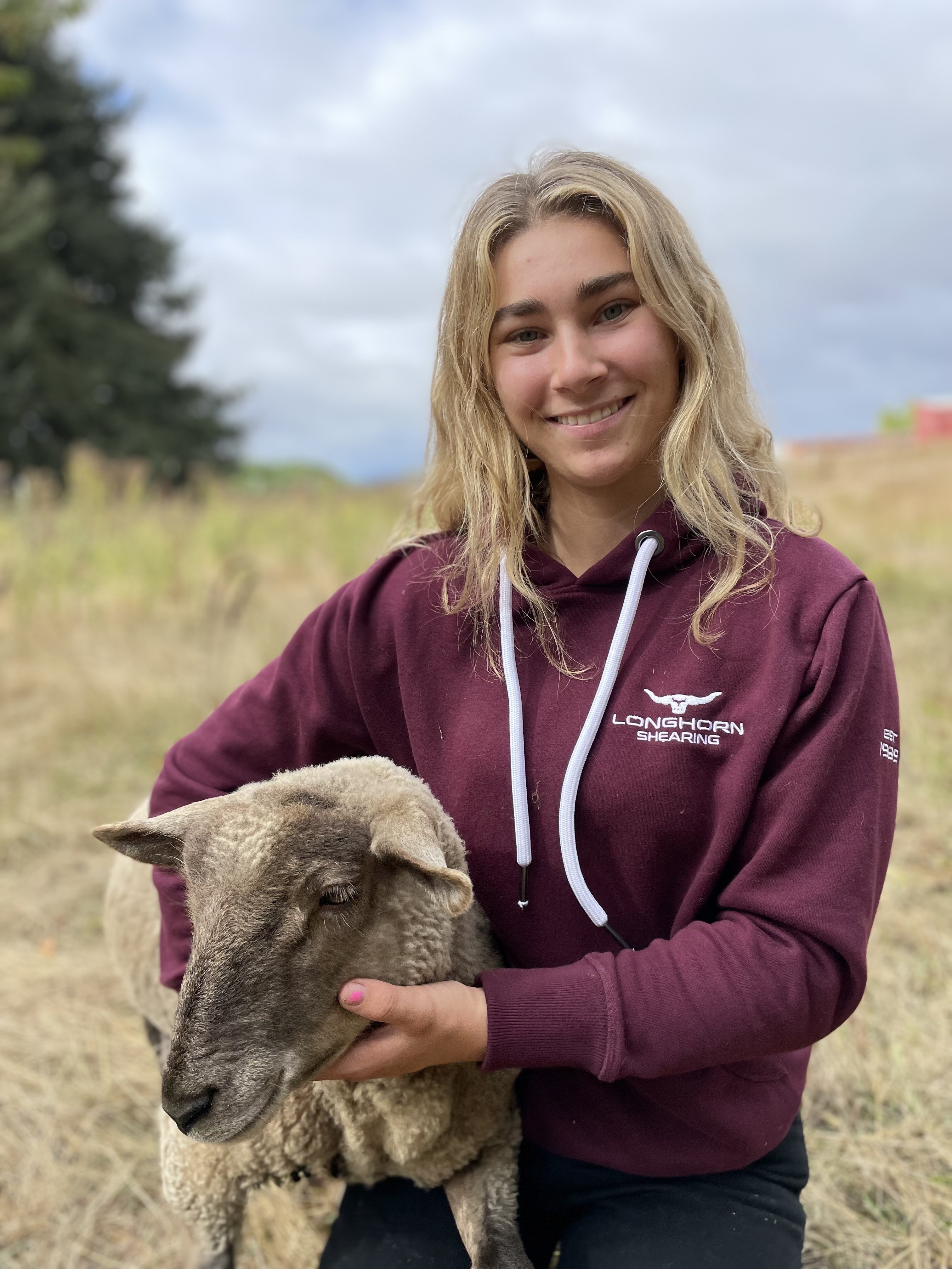 Phoebe Smith holding a sheep