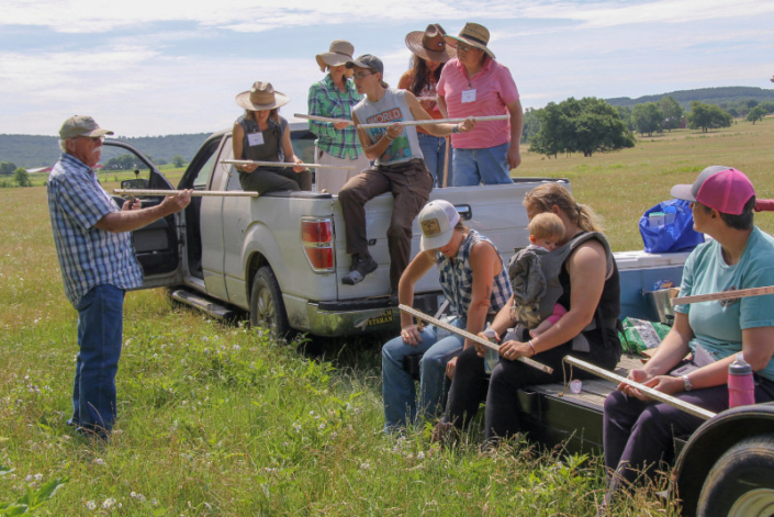 Dr. Ron Morrow shows a group of female attendees how to use a grazing stick