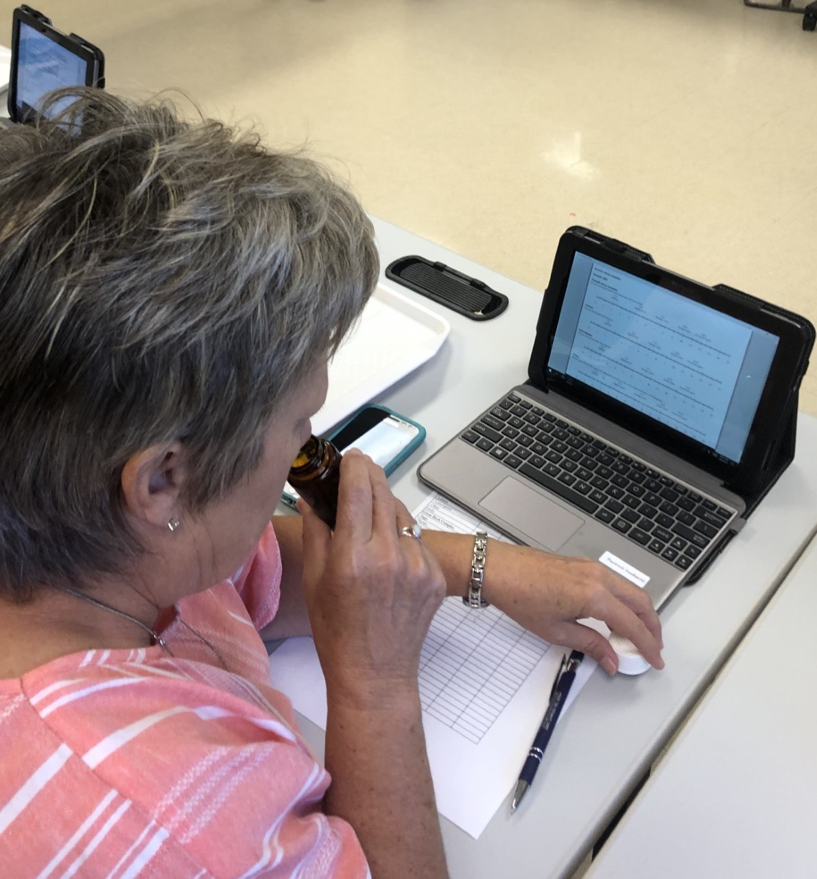 Photo of a woman smelling hops aroma for descriptive sensory evaluation at a hops sensory panel