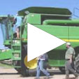 large tractor with two people walking by