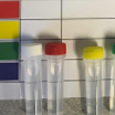 vials with colored lids on top of a page with a data table
