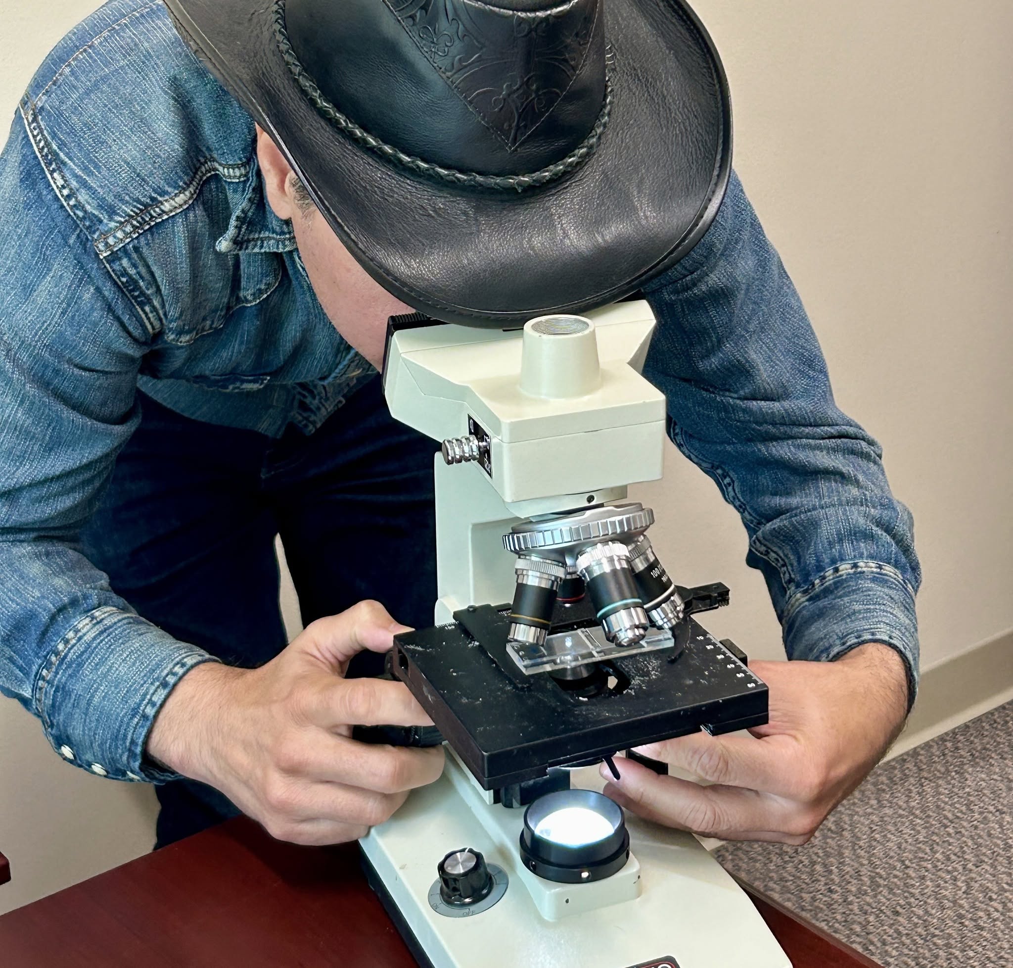 Man looking through microscope