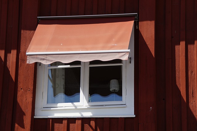 red house with awning on window