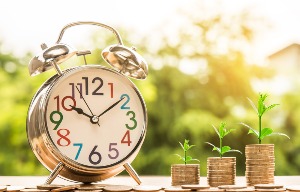 Alarm Clock and Plant Growing Out of Coins