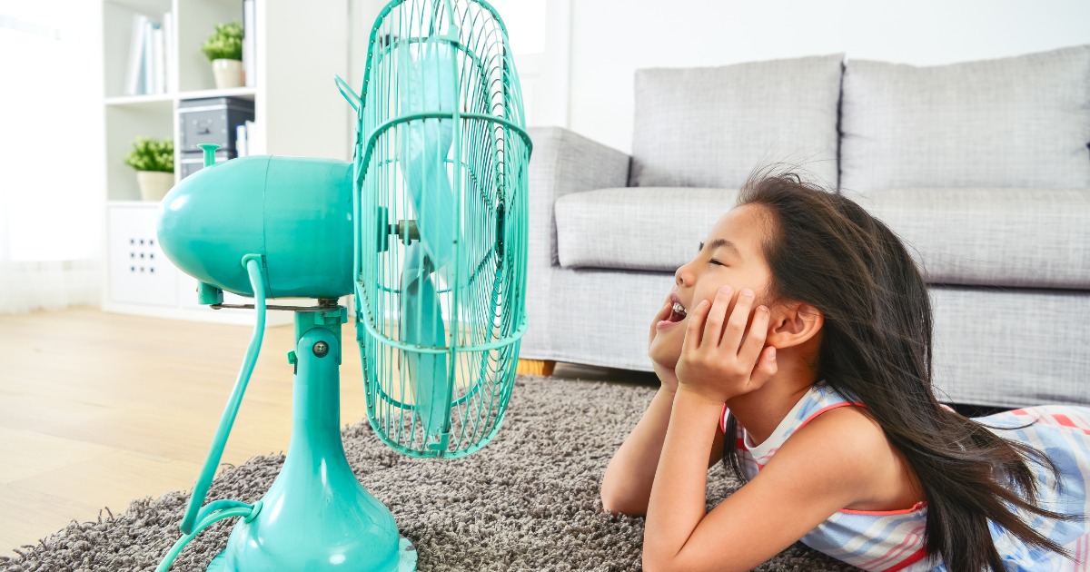 child cooling off in front of a fan