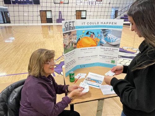 adult and student discussing display