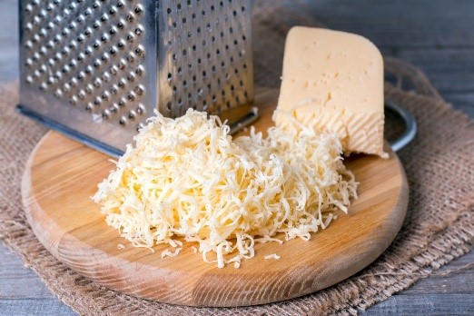 cheese on a cutting board, some whole some shredded