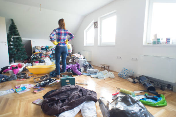 cluttered area with woman standing in the midst