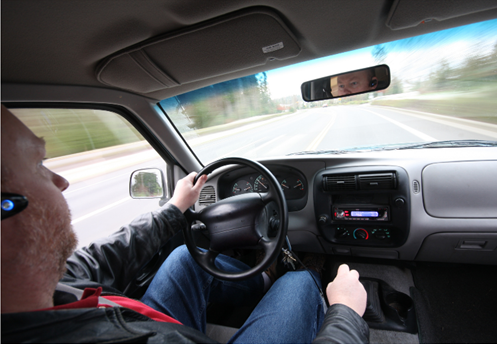 distracted driving Man driving distracted by hands-free cell phone use.