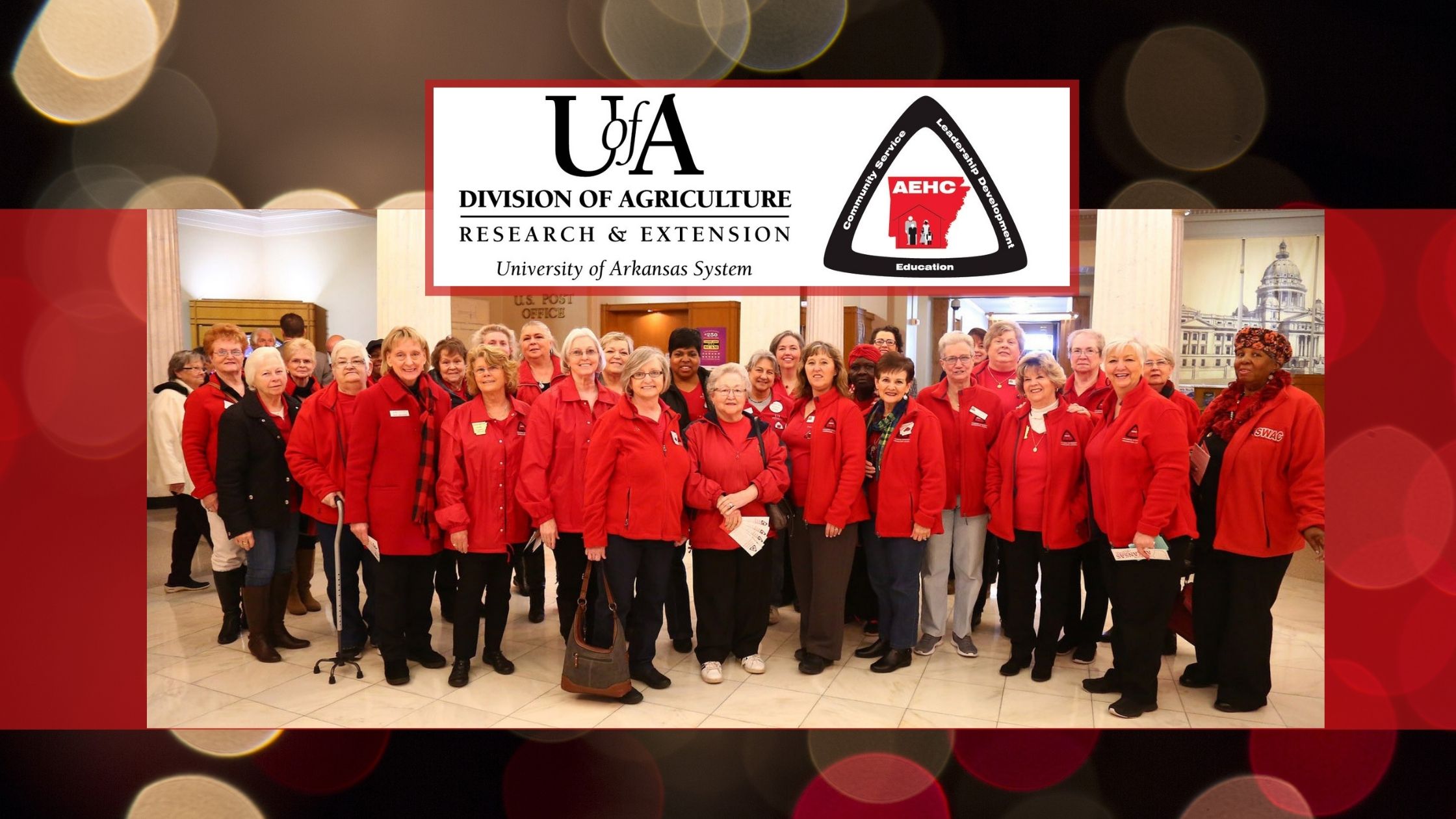 Large group of EHC members wearing their red EHC jackets and smiling at the camera. ECH logo at the top.
