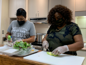 two women learning to make a recipe at a counter top