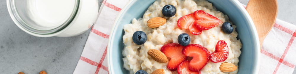 oatmeal with blueberries and strawberries with a side of milk
