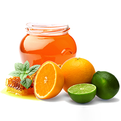 small grouping of a jar of honey with a sliced orange and lime