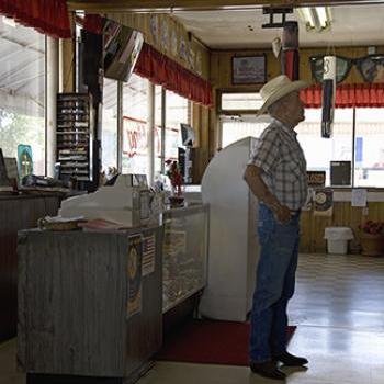 Man stands at check-out counter of local restaurant