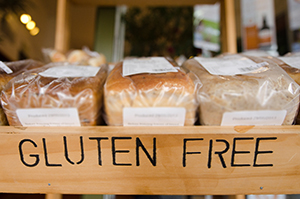 Shelf of loaves of bread with the word gluten free on the shelf