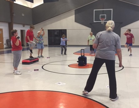 older women in a gym workout out in a group