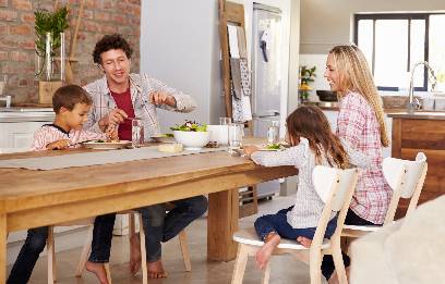 family dinner time family of four eating dinner at the kitchen table