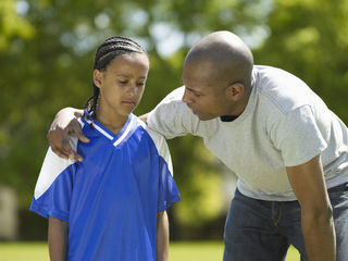 parent talking to child athlete