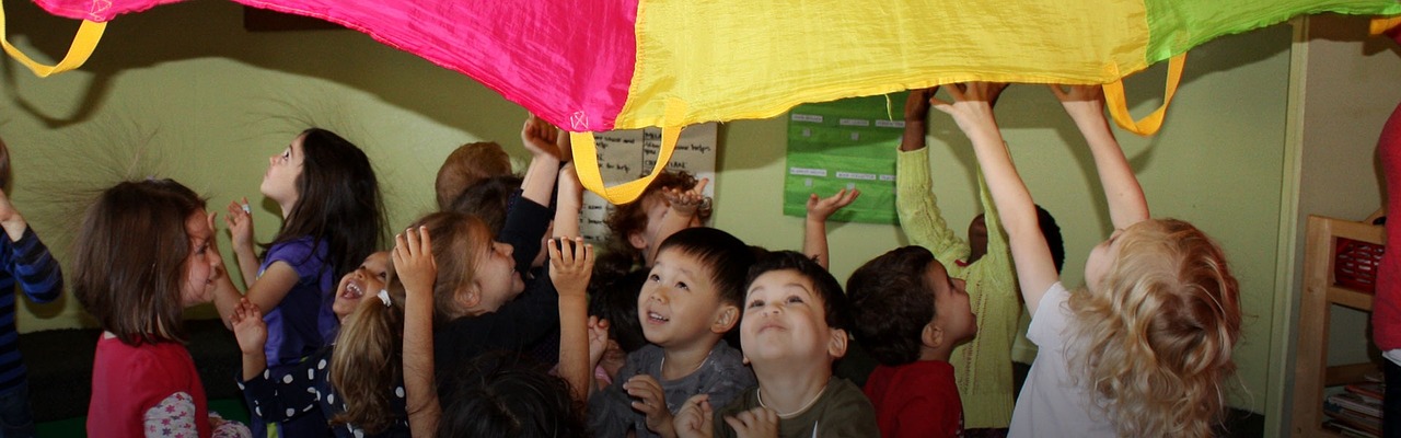 children playing with parachute