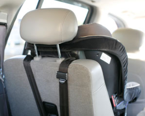 Front-facing car seat tethered to seat with straps