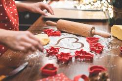 christmas cookie cutters and flour on a table