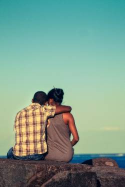 Man with arm around woman's shoulders