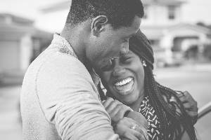 Man and woman hugging and smiling