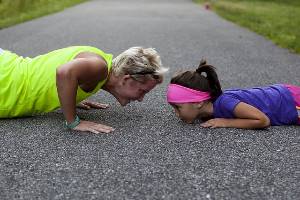 woman and girl doing pushups