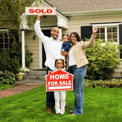 family in front of house