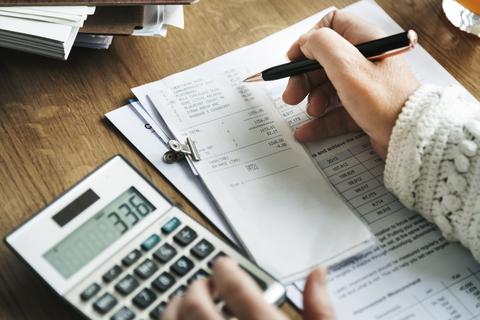 person calculating expenses and and budgeting