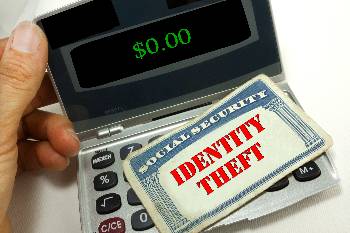 Protect yourself agains identity theft person holding a calculator with a social security card that says identity theft on it