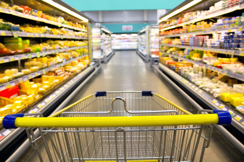 Empty grocery cart in store aisle