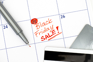 Black friday sales can be both good and bad for consumers calculator and credit card on top of a calendar marked with Friday as black friday