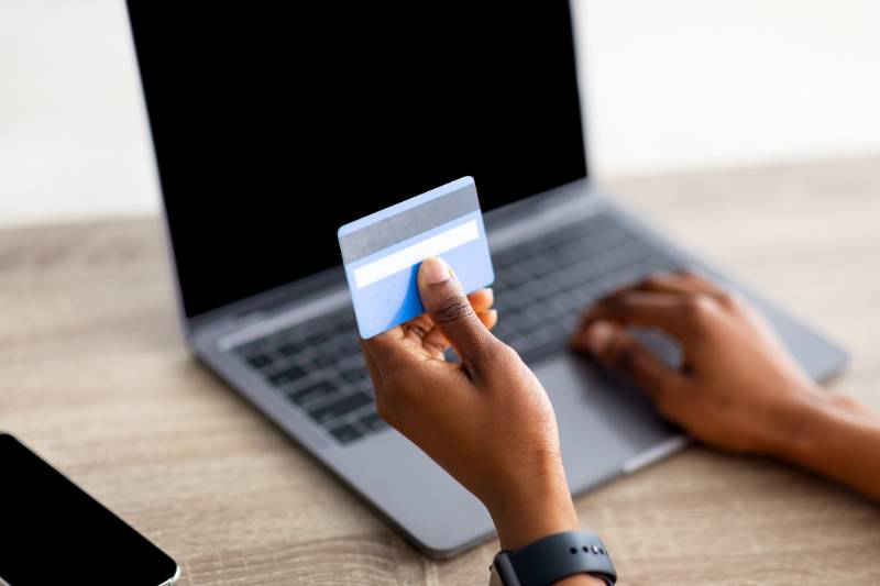 Online shopper holds a credit card.
