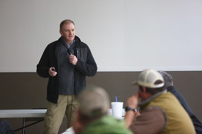 Scott Stiles speaks into a microphone to a crowd