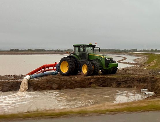 Tractor amidst a flooded field