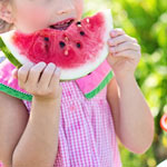 Child eating a watermelon.