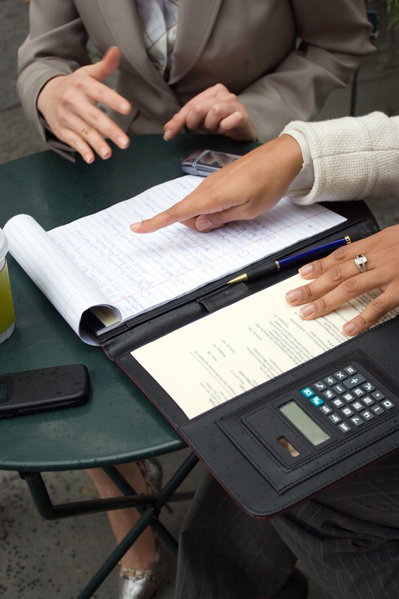 Two people looking over a notepad