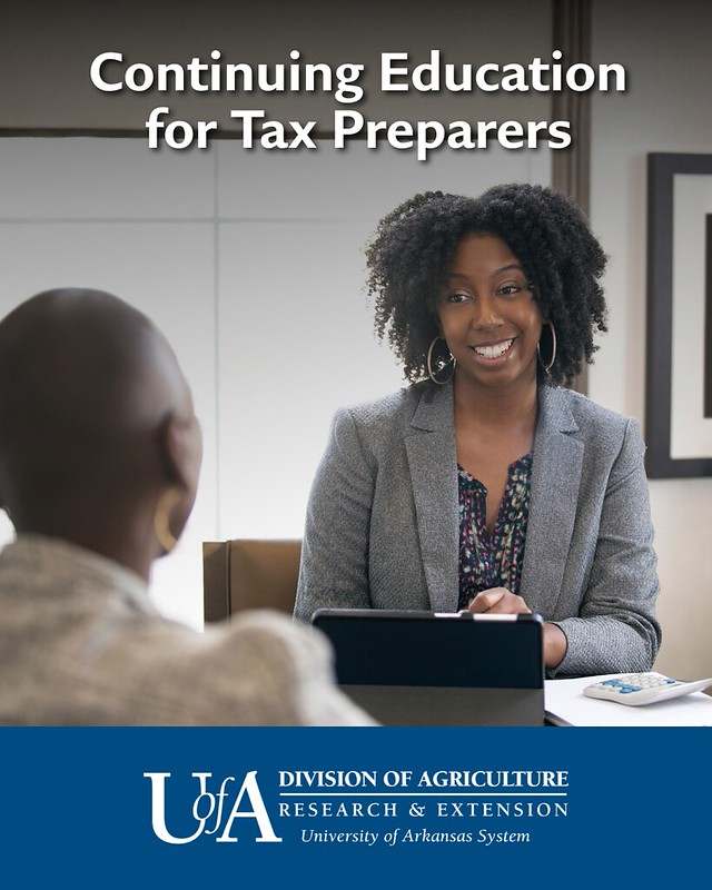 tax-prep.jpg Woman using a computer in office talks with a man.